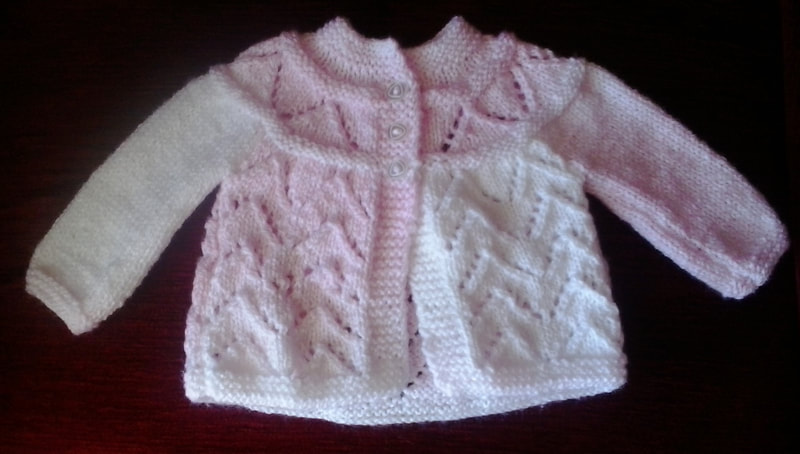 Hand knitted baby cardigan in pink and white for baby girl