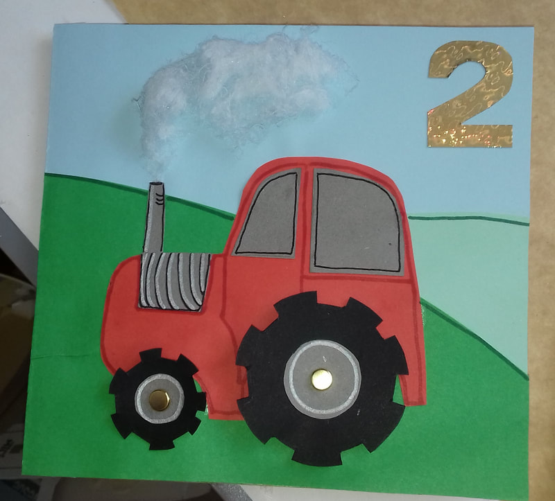 Handmade birthday card. 
tractor with moving wheels