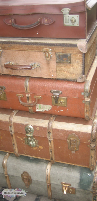 Photograph of old battered suitcases on the platform at Watchet station. Somerset