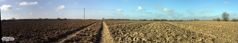 A panoramic photograph of a big ploughed field in NOrfolk, England