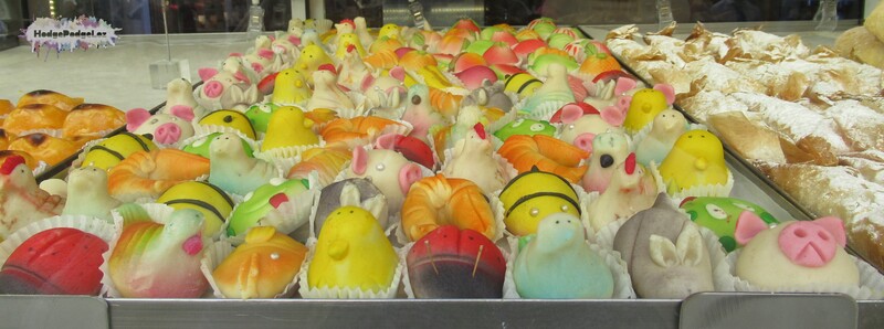 Photograph of sweet treats lined up on a bakery shelf