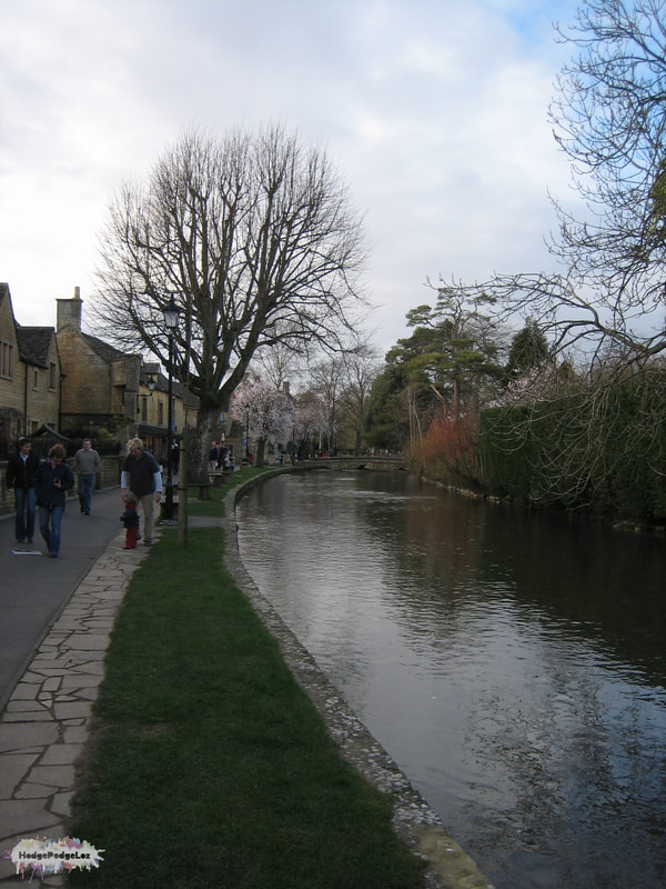 Photograph of Bourton on the Water, including river and buildings. 