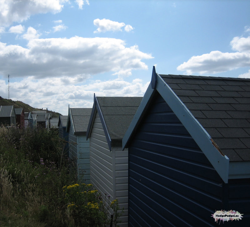 Beach huts against a blue sky at the coast in Milford-on-Sea