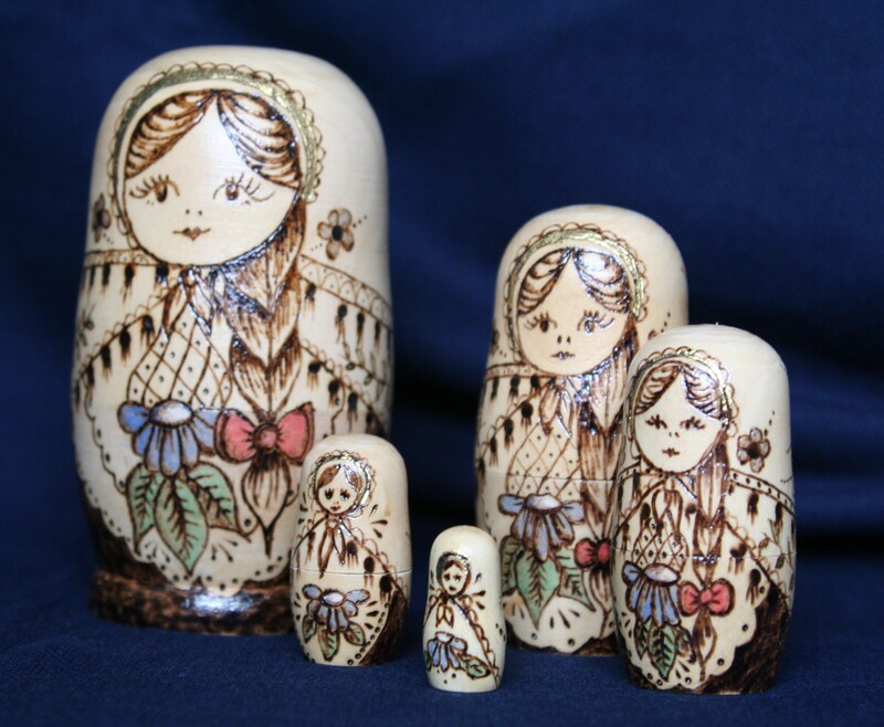 Photograph of set of 5 Russian dolls decorated using pyrography