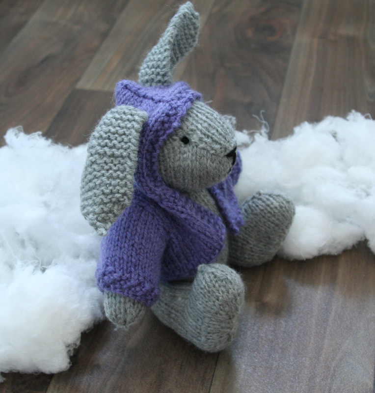 Photograph of cute grey bunny wearing a purple hoodie. Hand knitted. Available on Etsy. 