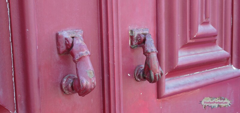 Photograph of unusual door knockers on a red door