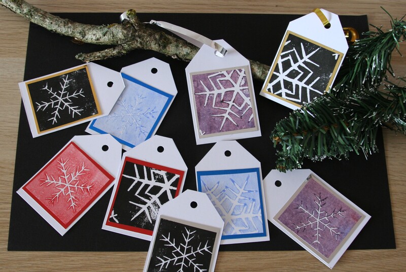 Photographs of linocut Christmas Snowflake Gift tags. 