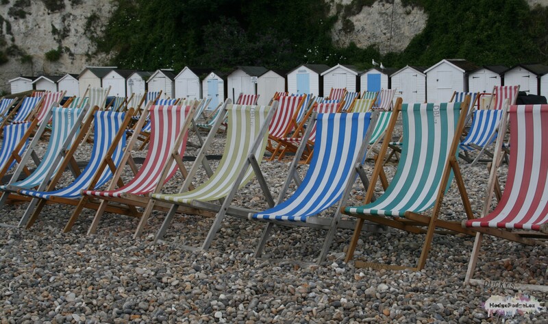 Photograph of deckchairs on the beach in Beer, Devon, England
