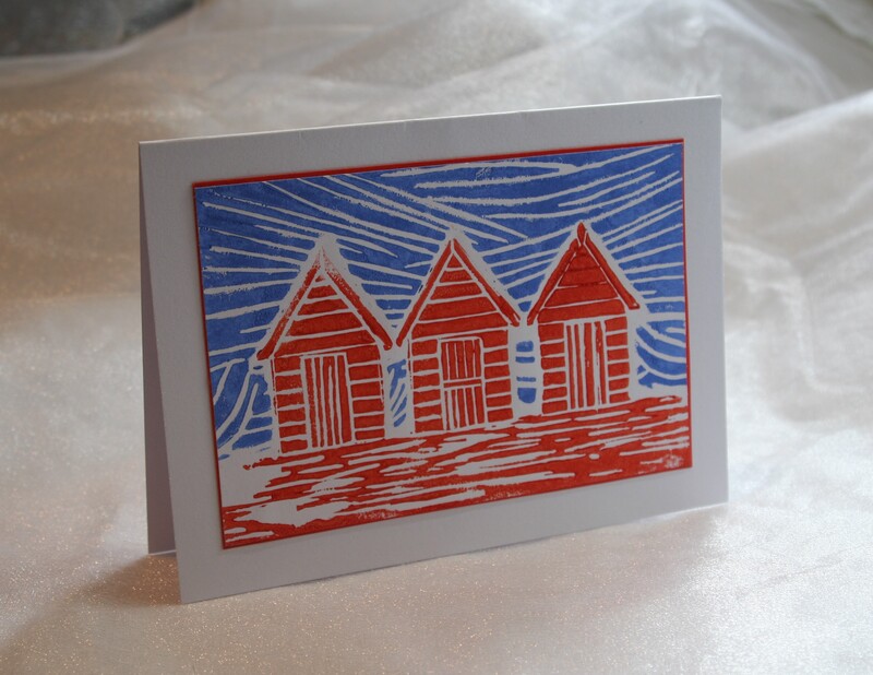 Beach hut lino printed card in blue and red. Available for purchase