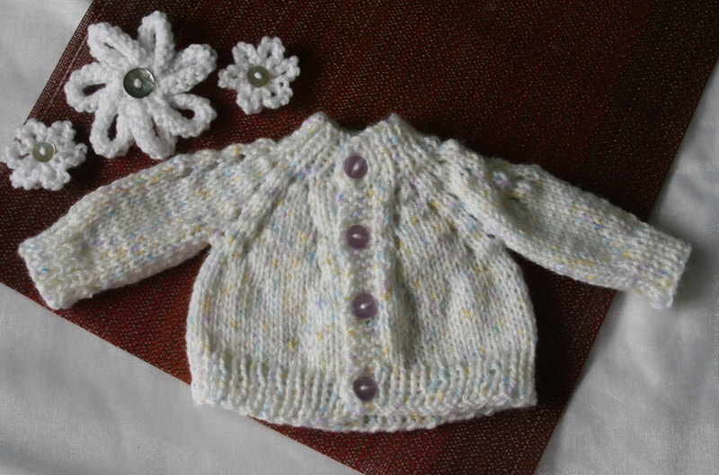 Premature baby cardigan in white. Available in Etsy store. 