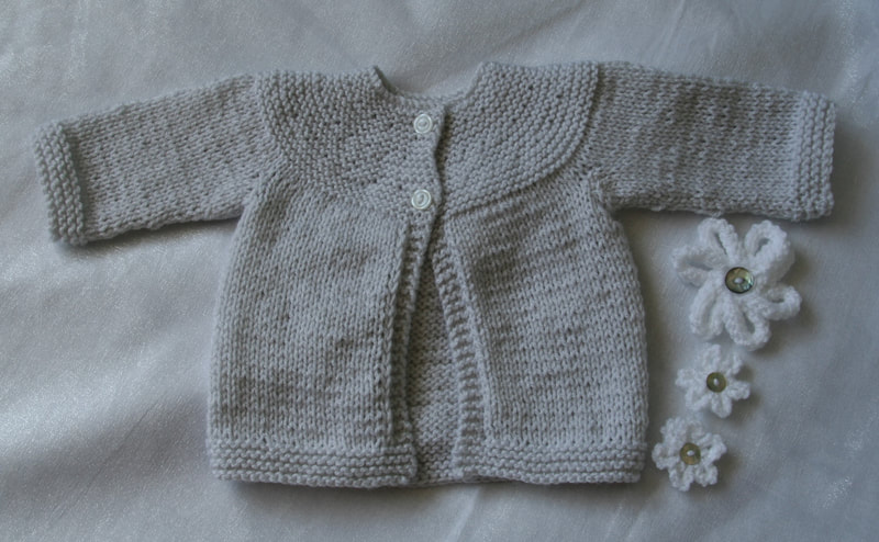 A modern yoke necked cardigan in soft grey with two buttons. Available in Etsy store