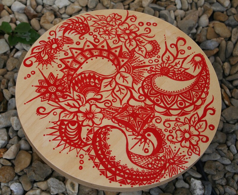 Wooden table top decorated with a henna like pattern